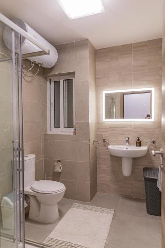 a bathroom with a toilet and a sink at Sliema Coastal Bloom Retreat in Sliema