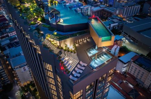 a view of a building with a swimming pool at night at The Edge Central Pattaya Seaview in Pattaya