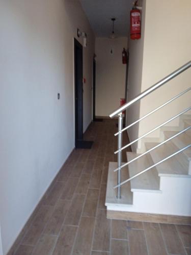 an empty hallway with stairs and a door at Golden village in Astakós