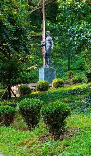 a statue of a man standing on top of a field at Vake Residence close to Park Mziuri in Tbilisi City