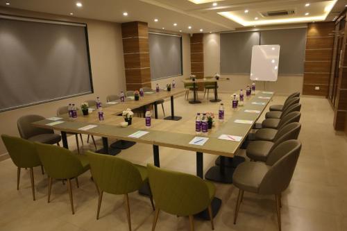 a conference room with a long table and chairs at Hotel Sharda Residency in Patna