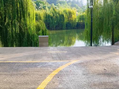 a parking lot with a body of water and a street at Vake Residence close to Park Mziuri in Tbilisi City