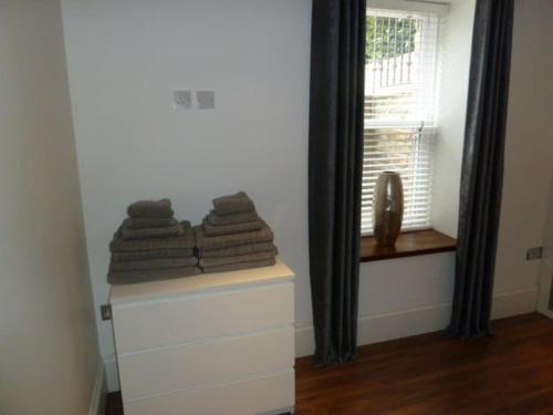 a room with a pile of towels on a dresser at 2 Bed Apt close to City Centre in Sheffield