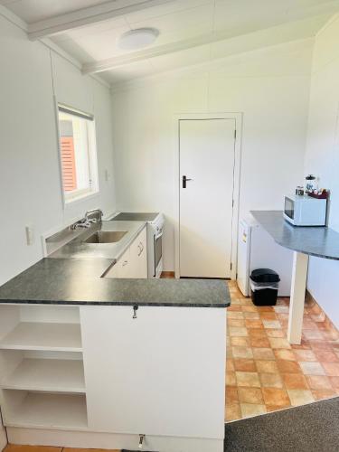 a kitchen with a sink and a counter top at 18th Avenue Thermal Motel in Tauranga