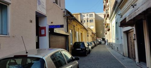 a row of cars parked on a street with buildings at River Hostel Belgrade in Belgrade