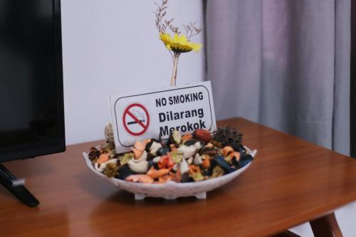 a bowl of food on a table with a no smoking sign at SS Ipoh Comfort Homestay - Taman Bertuah in Ipoh