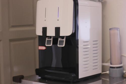 a white mixer sitting on a counter next to a blender at SS Ipoh Comfort Homestay - Taman Bertuah in Ipoh