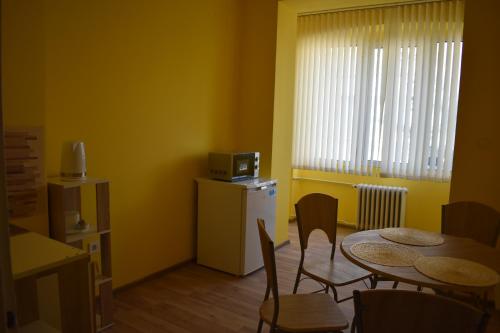 a small room with a table and chairs and a kitchen at Apartment Airport Sofia in Sofia