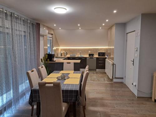a kitchen and dining room with a table and chairs at Apartman President in Krapinske Toplice