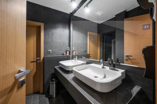 a bathroom with two sinks and a large mirror at Prince Rooftop in Belgrade