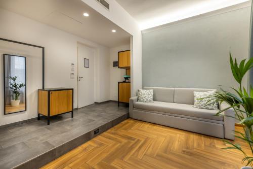 a living room with a couch and a table at URBANFLORA in Genova