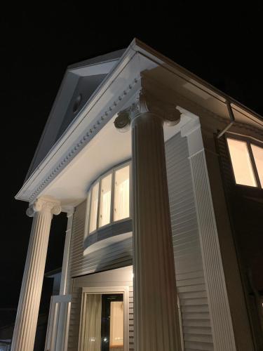 a white house with a pillar and a window at HAKONE DOMA in Hakone