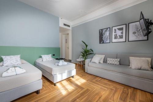 a living room with two beds and a couch at URBANFLORA in Genova