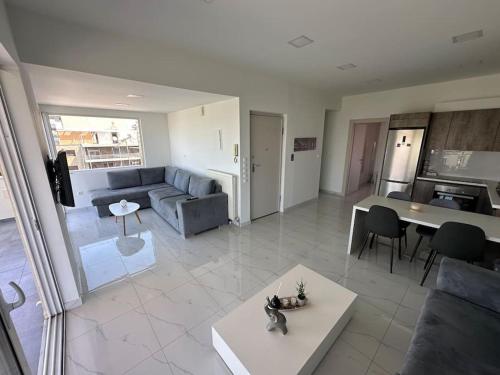 a living room with a couch and a table at Floisvos Penthouse Oasis in Athens
