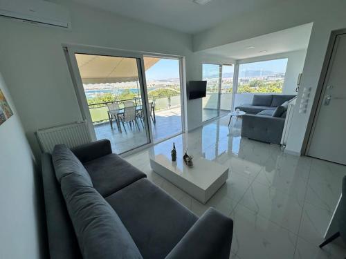 a living room with a couch and a table at Floisvos Penthouse Oasis in Athens