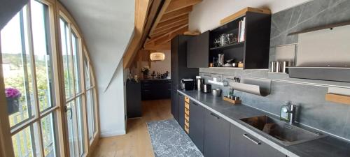 a kitchen with a sink and a large window at Villa Florentina in Bad Wörishofen