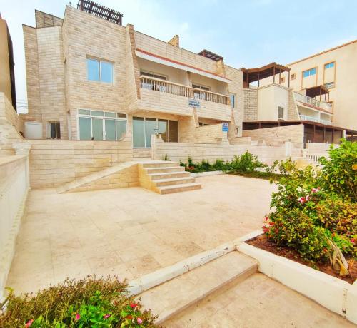 an apartment building with a courtyard in front of it at SEA VILLAS Salalah in Salalah