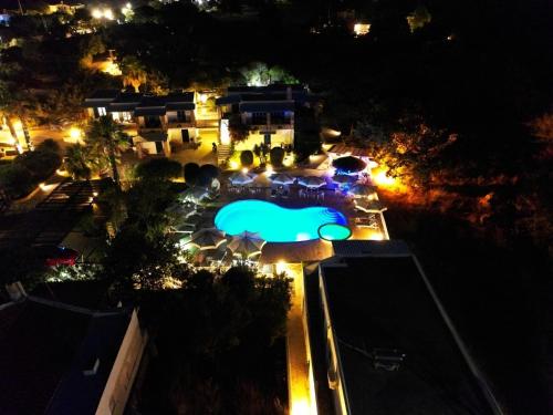 an overhead view of a pool at night at Anemousa Studios in Otzias
