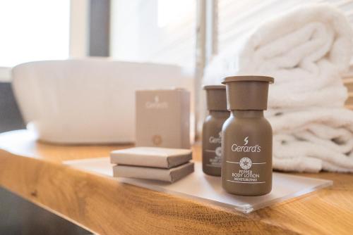 a table with two bottles of hair products on it at Encanto Agriturismo & Private SPA in Visogliano