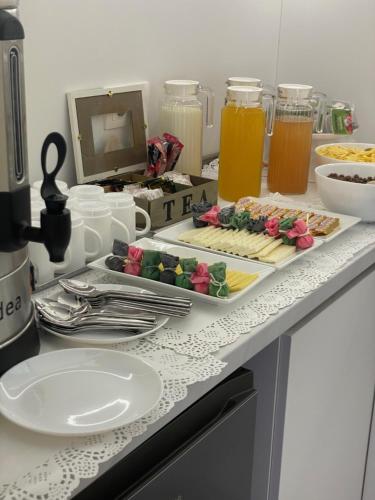 a table with plates of food and drinks on it at Hotel Avenue 30 in Yerevan