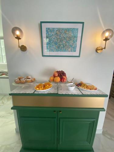 a counter with plates of fruit on it at Hotel Avenue 30 in Yerevan