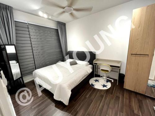 a bedroom with a white bed and a ceiling fan at Geo Bukit Rimau Apartment in Shah Alam