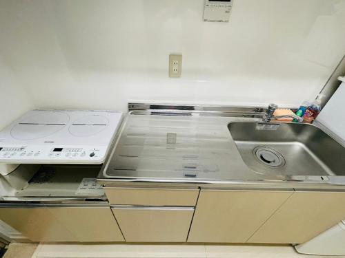 a kitchen with a sink and a counter top at STUDIO YONEGAHAMA l 米が浜通 in Yokosuka