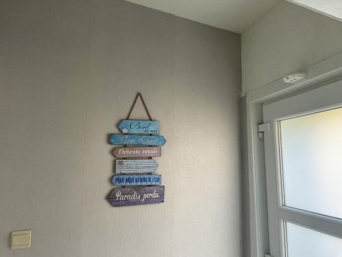 a group of signs on a wall next to a door at 2 bedrooms appartement with wifi at Charleroi in Charleroi