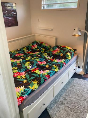 ein Bett mit einer bunten Bettdecke darauf in der Unterkunft Annexet in Hässleholm