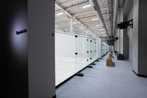 a long hallway with a row of tennis courts at INVENTIST Hotel Sports Academy Istanbul in Istanbul