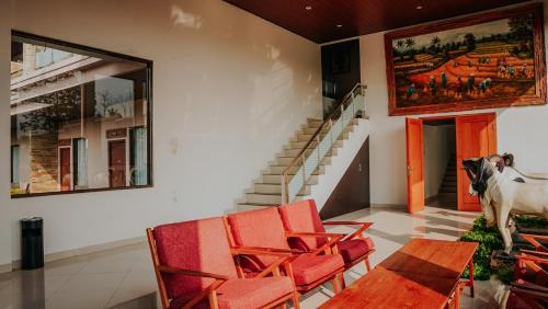 a room with chairs and a cow on the wall at Villa Rancabango Hotel & Resort Garut in Tarogong