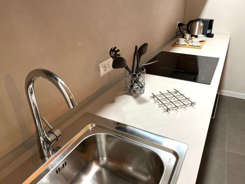 a kitchen with a sink and a counter top at Ca'Sazen Trilo 19 in Brescia