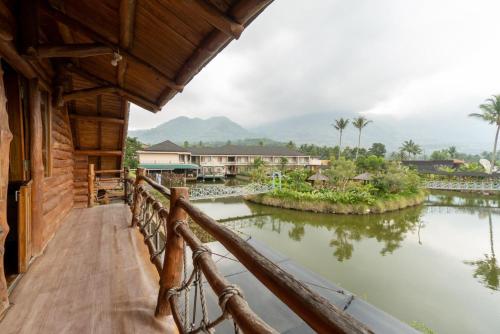 a balcony of a house with a river at Villa Rancabango Hotel & Resort Garut in Tarogong