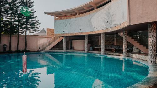 a large swimming pool in the middle of a building at Villa Rancabango Hotel & Resort Garut in Tarogong