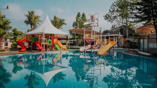 a swimming pool with slides and a water park at Villa Rancabango Hotel & Resort Garut in Tarogong