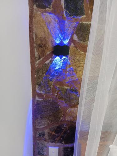 a stairway with a blue light in the middle at Ella glory inn in Ella
