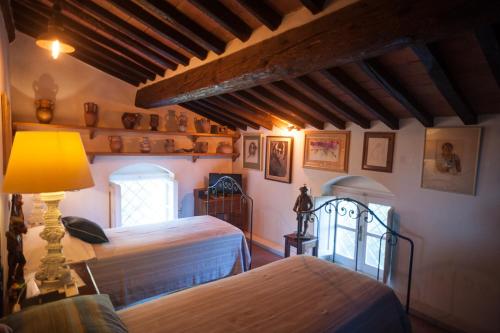 a bedroom with two beds and a lamp at Villa Marinsky Pietrasanta , Lucca in Pietrasanta