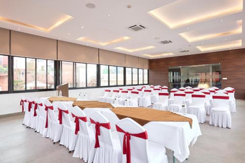 a conference room with tables and chairs with red bows at Kantipur Village in Kathmandu