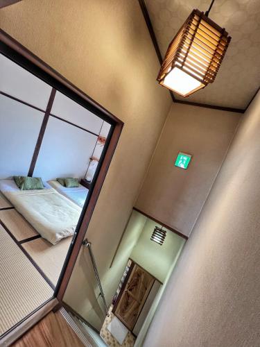 a small room with a mirror and a bed at Bighem Maison in Izumi-Sano