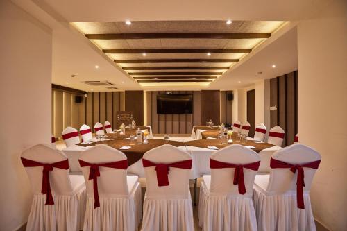 a conference room with a long table with red bows at Kantipur Village in Kathmandu