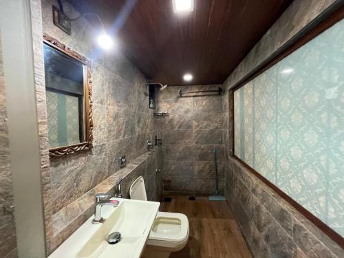 a bathroom with a sink and a toilet at Rocky in Mumbai
