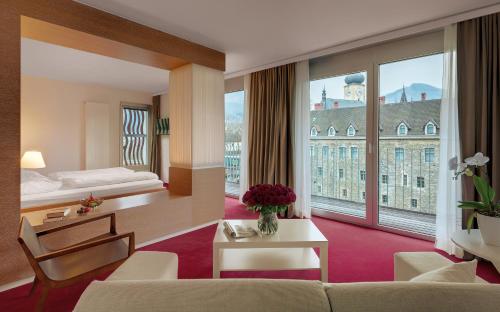 a hotel room with a bed and a large window at Das Schloss an der Eisenstrasse in Waidhofen an der Ybbs