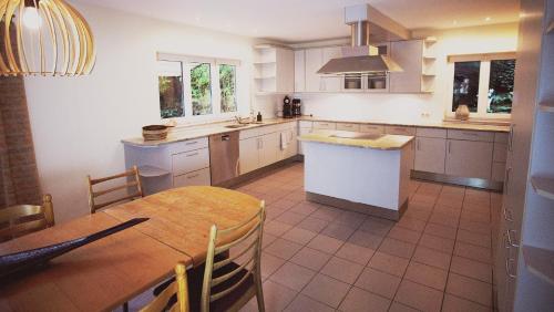 a kitchen with a table and a counter top at Apartmenthaus Oberndorf in Oberndorf