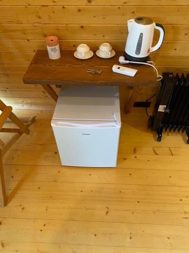 a table with a coffee maker on top of a box at Porto Gumati in Kutaisi