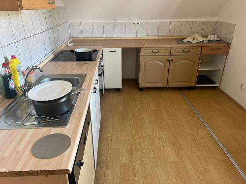 a small kitchen with a sink and a stove at Rose Gasthaus in Crailsheim