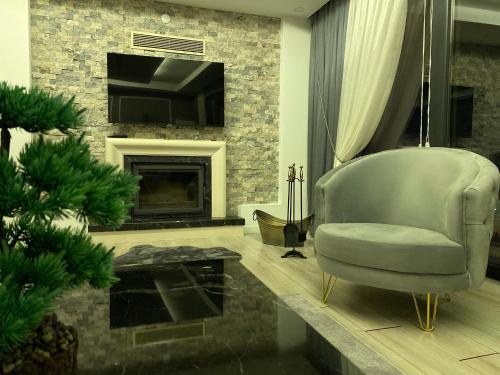 a living room with a chair and a fireplace at Villa Panorama Sapanca in Sapanca