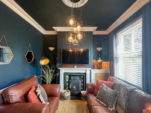 a living room with a couch and a fireplace at Park View in Quorndon