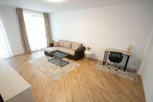 a living room with a couch and a table at DownTown Apartments in Rădăuţi