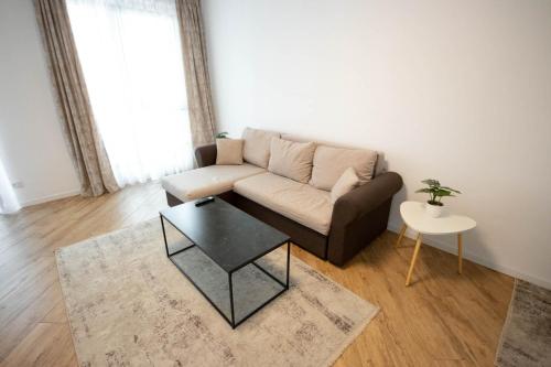 a living room with a couch and a table at DownTown Apartments in Rădăuţi