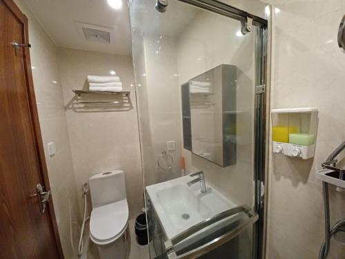 a bathroom with a sink and a glass shower at Gabs CozyHomes at MegaTower IV Condo, City Center Baguio in Baguio